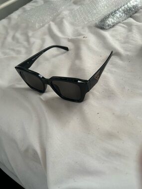 Prada Black Cat-Eye Sunglasses with Gold Logo Accent